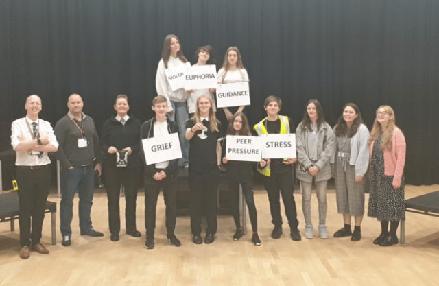 (L-R) Vice Principal, Joe Kenyon, two Merseyside police officers, students, Helen Abbot, head of Drama, and Sam Hett, teacher, with props used for the performance