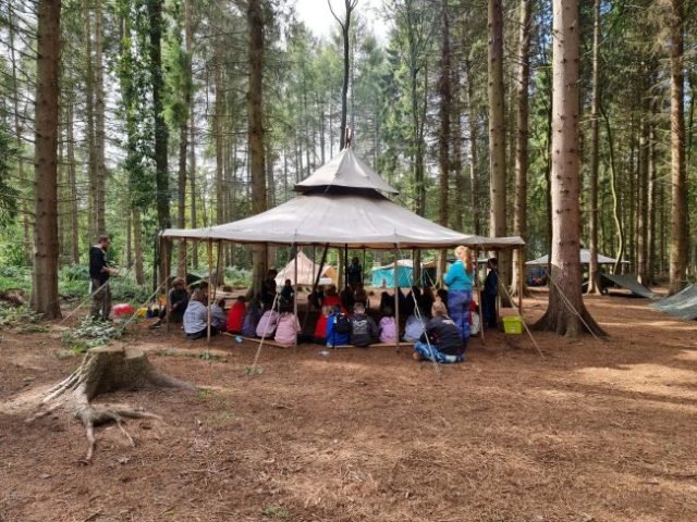 Year 7 students gathered around at camp