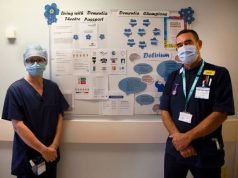 Mark Oakley (right), Admiral Dementia Nurse and Kellie Baldwin (left), Deputy Team Leader Operating Department Practitioner next to the Dementia Theatre Passport Board