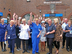 WWL CEO Silas Nicholls (far left) celebrates with staff at the Thomas Linacre Centre, Wigan.