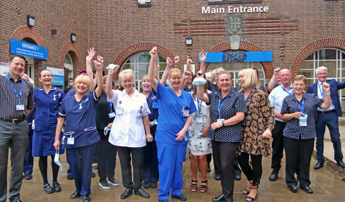 WWL CEO Silas Nicholls (far left) celebrates with staff at the Thomas Linacre Centre, Wigan.