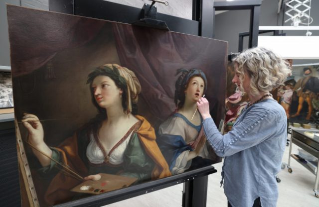 Rebecca Kench, painting conservator, works on Giovanni Andrea Sirani’s Allegory of Painting and Music. c. Gareth Jones